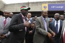 Kenya's Deputy President Ruto bids farewell to government officials as he leaves Jomo Kenyatta airport in Nairobi, on his way to the ICC at The Hague