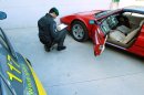 This undated handout photo provided on Oct. 24, 2012 by the the Guardia di Finanza, Italy's financial police corps, shows a tax police officer next to a confiscated Ferrari, at the Guardia di Finanza quarters, in Pescara, Italy. Good plumbers might be worth their weight in gold, but when one was spotted zipping around near the town of Pescara in a bright red Ferrari, Italian tax police were fast on his trail. Eradicating entrenched, endemic tax evasion is crucial to Premier Mario Monti's quest to keep Italy from succumbing to the European debt crisis, and it is critical to fellow euro-zone members in more dire straits, such as Greece and Spain. (AP Photo/Courtesy of the Guardia di Finanza, ho)