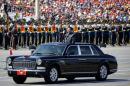 Chinese President Xi Jinping stands in a car to review the army during a parade commemorating the 70th anniversary of Japan's surrender during World War II held in front of Tiananmen Gate in Beijing, Thursday, Sept. 3, 2015. The spectacle involved more than 12,000 troops, 500 pieces of military hardware and 200 aircraft of various types, representing what military officials say is the Chinese military's most cutting-edge technology. (AP Photo/Ng Han Guan)