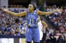 FILE - In this Oct. 11, 2015 file photo, Minnesota Lynx's Renee Montgomery holds out her arms in the first half of Game 4 of the WNBA Finals basketball series against the Indiana Fever, in Indianapolis. The NBA joins a long list of sports leagues that sells advertising space on their jerseys. (AP Photo/Michael Conroy, File)