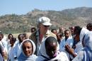 A picture taken on November 25, 2009, shows founder of the Band Aid charity Bob Geldof (C) with local people during a visit to Korem in Ethiopia