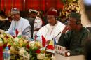 Chad's President Idriss Deby and Niger counterpart Mahamadou Issoufou listen to Nigerian President Muhammadu Buhari during Summit of Heads of State and Governments of the Lake Chad Basin Commission in Abuja