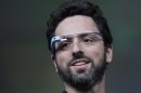 Google co-founder Sergey Brin demonstrates Google's new Glass, wearable internet glasses, at the Google I/O conference in San Francisco, Wednesday, June 27, 2012. The audience got live video feeds from their glasses as they descended to land on the roof of the Moscone Center, the location of the conference. (AP Photo/Paul Sakuma)