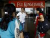 Passengers wait outside the Kingfisher Airlines reservation counter after their flight was canceled at the domestic airport in Mumbai, India, Monday, Oct 1, 2012 Kingfisher says it has canceled several flights Monday due to a labor dispute with its workforce, local media reported. (AP Photo/Rafiq Maqbool)