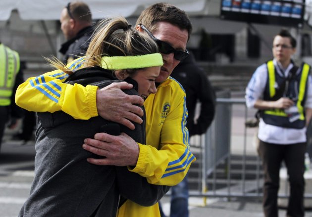 A woman is comforted by a man near a triage tent set up for the Boston Marathon after explosions went off at the 117th Boston Marathon in Boston