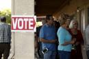 People wait to vote in the U.S. presidential primary election at a polling site in Arizona