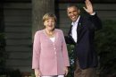 President Barack Obama greets Germany's Chancellor Angela Merkel as she arrives at the G8 Summit at Camp David