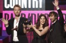 FILE - In a Nov. 20, 2011, file photo Lady Antebellum musical group members from left, Charles Kelley, Hillary Scott and Dave Haywood, accept the award for country band, duo or group at the 39th Annual American Music Awards on in Los Angeles. Grammy-winning Lady Antebellum is scheduled to perform Wednesday night, May 16, 2012, at the KFC Yum Center in Louisville, Ky., to raise money for rebuilding Henryville, Ind., about 20 miles to the north. (AP Photo/Matt Sayles, File)