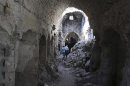 People walk through rubble in the old city of Aleppo