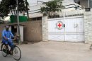 A Pakistani cyclist rides past the office of the International Committee of the Red Cross (ICRC) in Peshawar