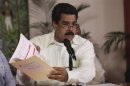 Venezuela's Vice President Nicolas Maduro speaks to state TV after arriving from Cuba in Caracas
