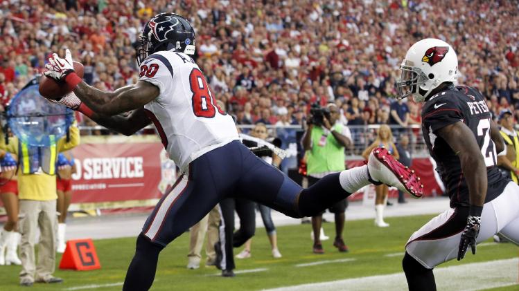 Houston Texans wide receiver Andre Johnson, left, makes a touchdown catch as Arizona Cardinals cornerback Patrick Peterson defends during the first half of an NFL football game Sunday, Nov. 10, 2013, in Glendale, Ariz