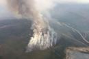 Smoke rises from a wildfire east of Slave Lake Alberta