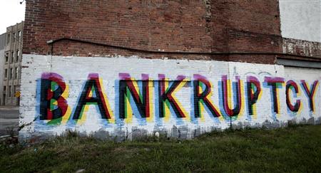 The word 'Bankruptcy' is seen painted on the side of a vacant building by street artists as a statement on the financial affairs of the city on Grand River Avenue in Detroit, Michigan July 26, 2013. REUTERS/Rebecca Cook