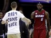 A fan runs out on the court towards Miami Heat's LeBron James during the fourth quarter of an NBA basketball game against the Cleveland Cavaliers on Wednesday, March 20, 2013, in Cleveland. Miami won 98-95. (AP Photo/Tony Dejak)