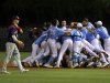 North Carolina celebrates their 12-11 win over Florida Atlantic in 13 innings during an NCAA college regional championship baseball game in Chapel Hill, N.C., Monday, June 3, 2013, as Florida Atlantic's Brendon Sanger, left, walks off the field.  (AP Photo/Ted Richardson)