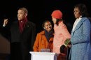 U.S. President Obama gestures next to his daughters Sasha and Malia after they light National Christmas Tree next to their mother at official lighting ceremony on Ellipse in Washington