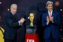 Vice President Joe Biden and Secretary of State John Kerry applaud after unveiling the FIFA World Cup trophy, the actual trophy that will be awarded to the winner of this year's World Cup soccer tournament in Brazil, during a ceremony at the State Department in Washington, Monday, April 14, 2014. (AP Photo/Manuel Balce Ceneta)