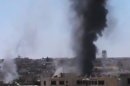 This image made from amateur video released by the Ugarit News and accessed Tuesday, June 19, 2012, purports to show black smoke rising from buildings in Rastan town, Homs, Syria. Syria's government said Tuesday it was ready to act on a U.N. call to evacuate civilians trapped in the rebellious central city of Homs for more than a week, but blamed rebels for obstructing efforts to get them out. (AP Photo/Ugarit News via AP video) TV OUT, THE ASSOCIATED PRESS CANNOT INDEPENDENTLY VERIFY THE CONTENT, DATE, LOCATION OR AUTHENTICITY OF THIS MATERIAL
