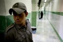 Prison guard stands along corridor in Tehran's Evin prison