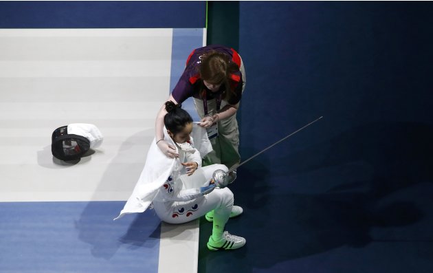 South Korea's Shin reacts after being defeated by Germany's Heidemann during their women's epee individual semifinal fencing competition at the ExCel venue at the London 2012 Olympic Games