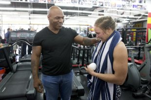 Ronda Rousey and Mike Tyson chat after her workout at Glendale Fighting Club on Wednesday. (AP)