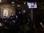 People watch as President Obama speaks about immigration reform on a television monitor at a restaurant in Phoenix