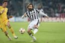 Juventus' Andrea Pirlo, right, challenges the ball with Atletico' Mario Mandzukic during a Champions League, Group A, soccer match between Juventus and Atletico de Madrid at the Juventus stadium in Turin, Italy, Tuesday, Dec. 9, 2014. (AP Photo/Massimo Pinca)