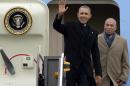 President Barack Obama waves as he is followed by Massachusetts Gov. Deval Patrick, right, upon his arrival on Air Force One at Logan Airport, Wednesday, March 5, 2014, in Boston. Obama traveled to Boston to attend a pair of Democratic fundraisers. (AP Photo/Charles Krupa)