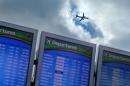AP10ThingsToSee - A plane takes off over a departure board at Hartsfield-Jackson Airport, Wednesday, Nov. 27, 2013, in Atlanta. (AP Photo/David Goldman, File)