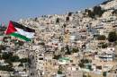 A Palestinian flag clies in front of buildings in the east Jerusalem neighborhood of Silwan on August 29, 2013