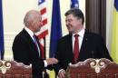 Ukraine's President Poroshenko and U.S. Vice President Biden smile as they arrive at a news conference in Kiev