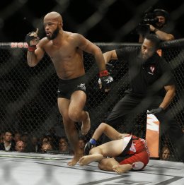 Demetrious Johnson celebrates after defeating Chris Cariaso at UFC 178. (AP)