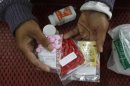 An HIV-infected patient displays medicine at a hospital in Payao province