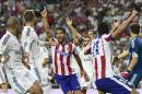 Atletico Madrid's midfielder Raul Garcia (C) celebrates after scoring during the Spanish Supercup first-leg football match Real Madrid CF vs Club Atletico de Madrid at the Santiago Bernabeu stadium in Madrid on August 19, 2014