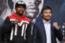 Boxers Floyd Mayweather Jr., left, and Manny Pacquiao pose for photographers during a press conference Wednesday, April 29, 2015, in Las Vegas. The pair are slated to square off Saturday in Las Vegas. (AP Photo/John Locher)