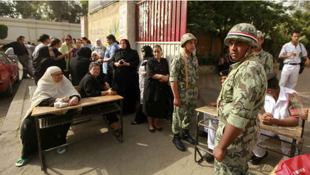 تحت شعار الجيش وشعب ايد وحده صور الجيش المصرى فى الانتخابات الرئاسية 120523065318-soldiers-stand-guard-as-people-wait-outside-a-polling-station-in-cairo-m-976x549-reuters-nocredit-jpg_094606