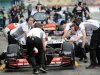 Mechanics push British driver Jenson Button's McLaren Mercedes' car in the pits in Hockenheim