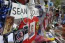 Photographs of slain Massachusetts Institute of Technology campus officer Sean Collier, center, are part of a makeshift memorial near the Boston Marathon finish line in Boston's Copley Square Tuesday, May 7, 2013 in remembrance of the Boston Marathon bombings. Authorities allege that the Boston Marathon bombing suspects were responsible for Colliers death. (AP Photo/Steven Senne)