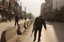 A rebel fighter walks down a street in the northern Syrian city of Aleppo on January 10, 2014