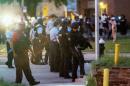 Police line up to block the street as protesters gathered after a shooting incident in St. Louis