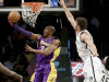 Los Angeles Lakers' Kobe Bryant, left, puts up a shot underneath the basket while Brooklyn Nets' Brook Lopez defends during the first half of the NBA basketball game at the Barclays Center Tuesday, Feb. 5, 2013 in New York. (AP Photo/Seth Wenig)