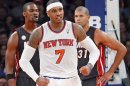 Knicks' Anthony reacts in front of Heat's Bosh and Battier in the fourth quarter of their NBA basketball game in New York