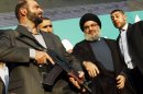 File picture shows Lebanon's Hezbollah leader Nasrallah greeting supporters at an anti-U.S. protest in Beirut's suburbs
