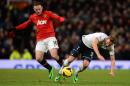 Tottenham Hotspur's English forward Harry Kane (R) vies with Manchester United's English striker Wayne Rooney (L) at Old Trafford in Manchester, northwest England, on January 1, 2014