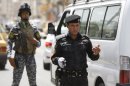 Iraqi police stop cars at a checkpoint in central Baghdad