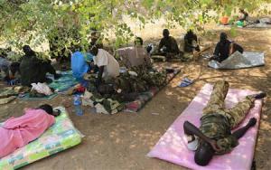 Wounded South Sudan military personnel receive medical treatment under a tree at the general military hospital compound in the capital Juba