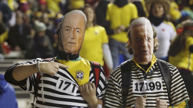 Brazil fans wear masks of FIFA Blatter and former Brazilian Soccer Confederation president Marin as they await the start of their team&#39;s first round Copa America 2015 soccer match against Colombia at Estadio Monumental David Arellano in Santiago