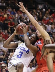 UCLA's Jordan Adams (3) puts up a shot against Arizona's Kaleb TArczewski in the second half during a semifinal Pac-12 tournament NCAA college basketball game, Friday, March 15, 2013, in Las Vegas. UCLA won 66-64.  (AP Photo/Julie Jacobson)