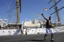 A crew member of the Argentine naval vessel Libertad prepares to leave the port for the beach, in Accra